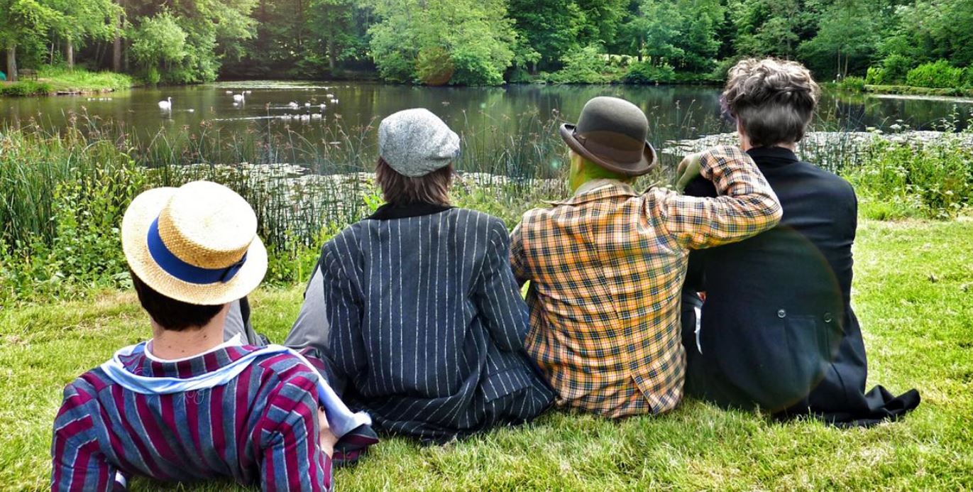 Actors from Wind in the Willows looking over a river dressed in costume
